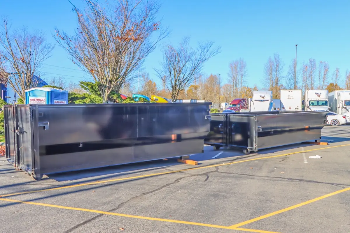 Professional dumpster rental service with roll-off container on residential driveway in King